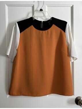 Gold, black, and white color block top